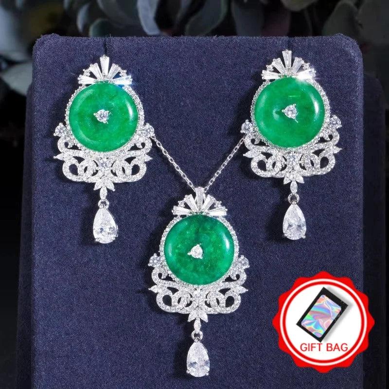 Green jade cabochon pendant necklace with matching drop earrings, silver zircon details