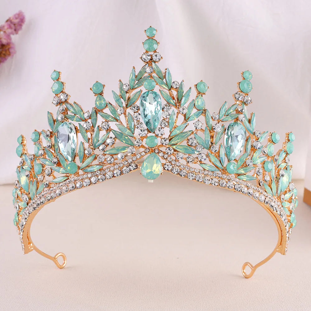 Crystal jeweled wedding tiara with teal green stones, arched crown and bright center gem