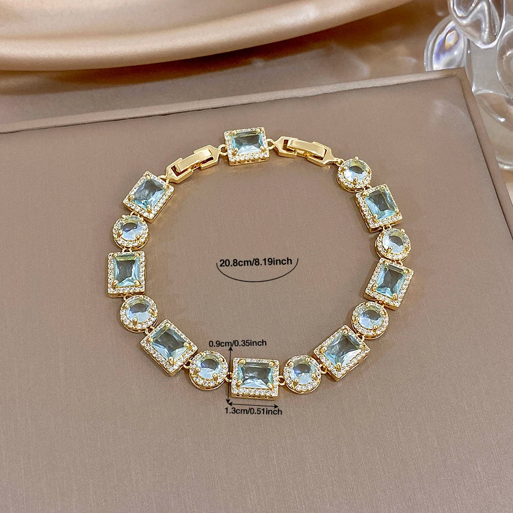 Gold-tone bracelet with blue square and round stones, 20.8cm length measurement shown