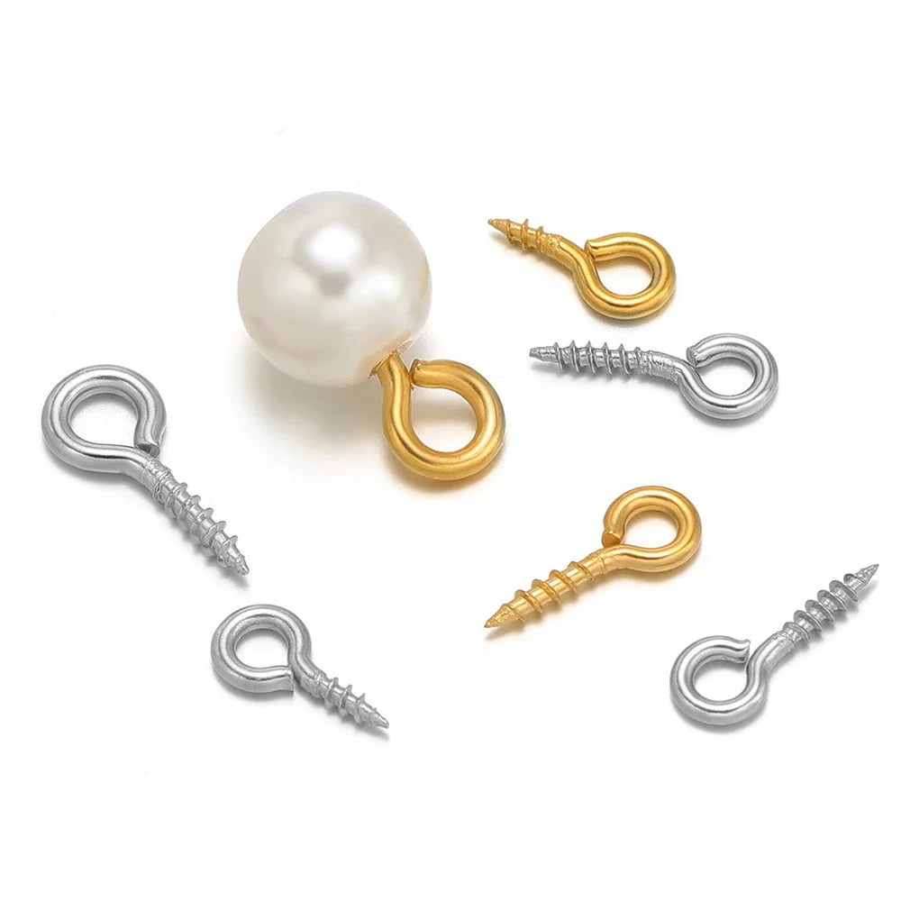 Gold and silver screw eye pins with threaded shafts, plus a pearl bead