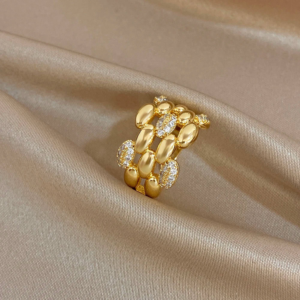 Gold-tone open geometric zircon cluster ring with sparkling clear stones