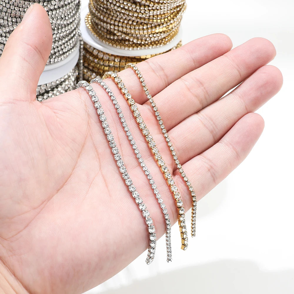 Hand holding gold and silver cubic zircon chain strands for bracelet and necklace DIY