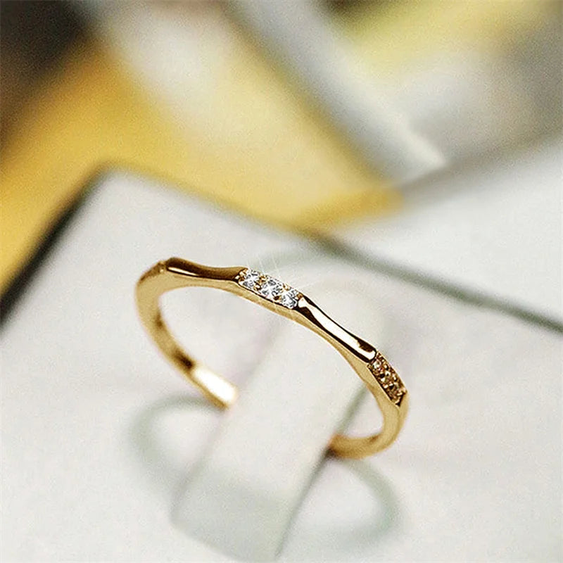 Gold-tone cubic zirconia minimalist wedding ring with three stones