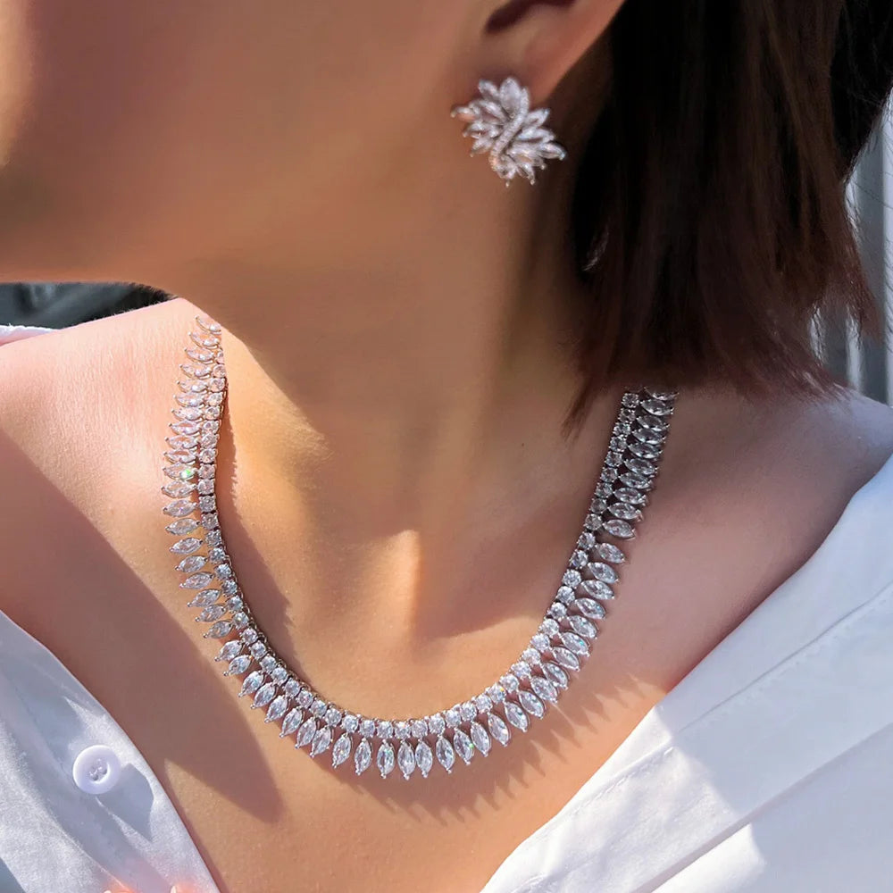 Leaf-shaped cubic zirconia necklace and matching floral stud earring, shown worn