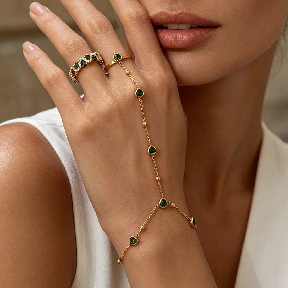 Gold-plated chain bracelet with green heart beads and matching ring on hand