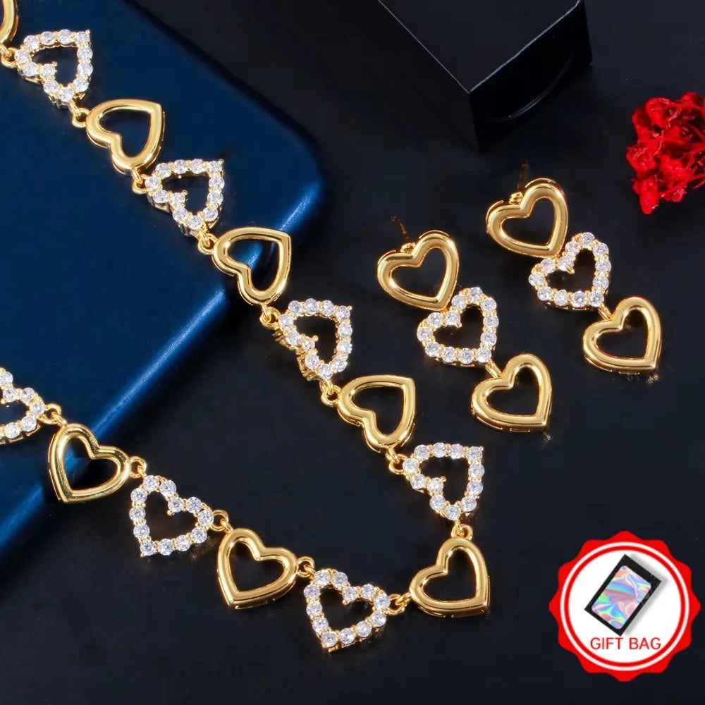 Gold heart necklace and matching drop earrings with clear cubic zirconia accents