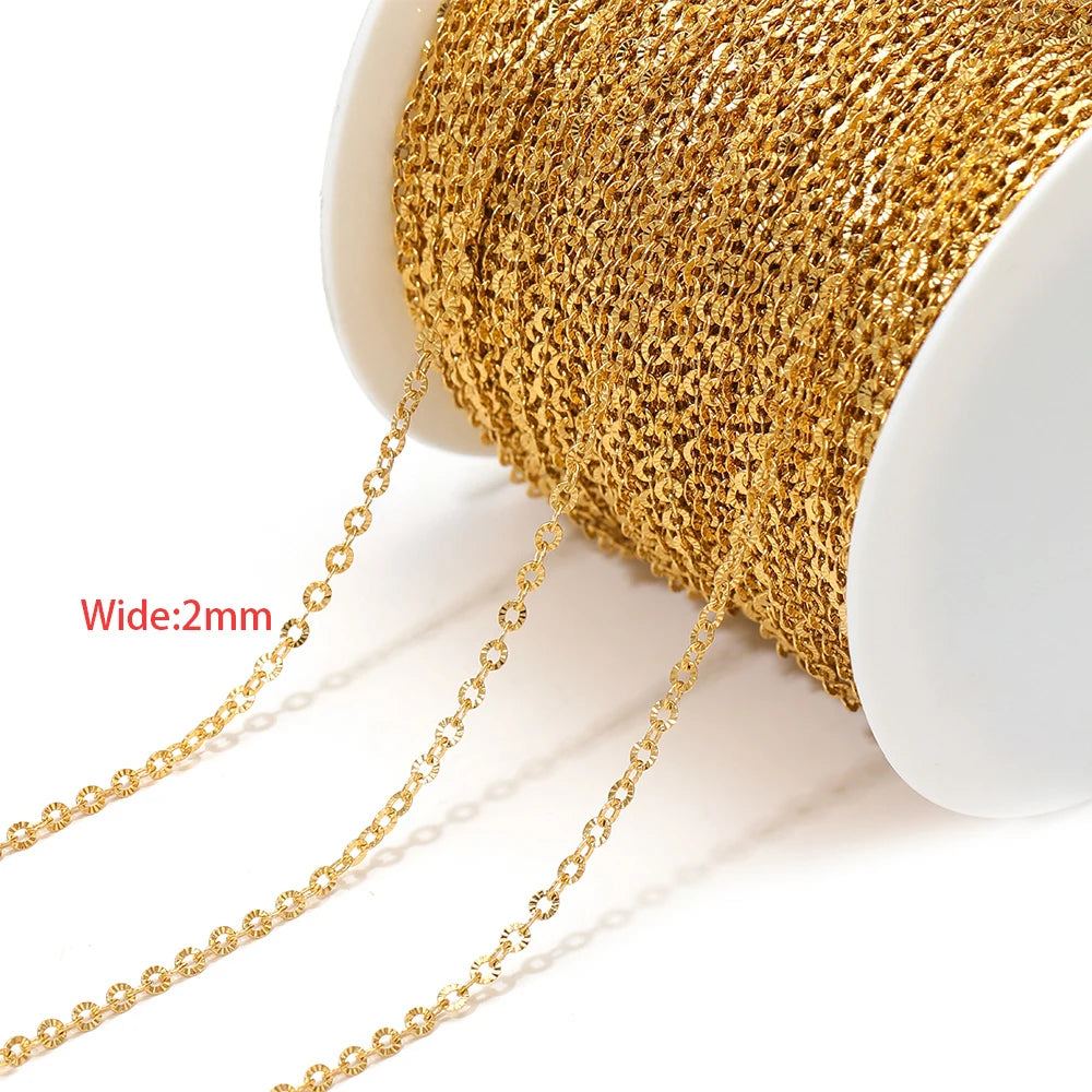 Fine gold textured chain mesh cord on a spool with dangling strands