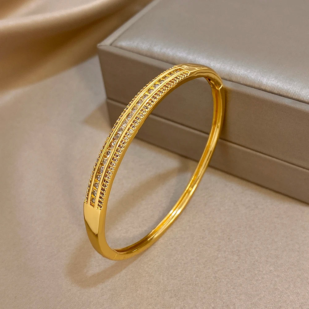 Gold-plated wide cuff bangle featuring micro zircon inlay along the curved surface