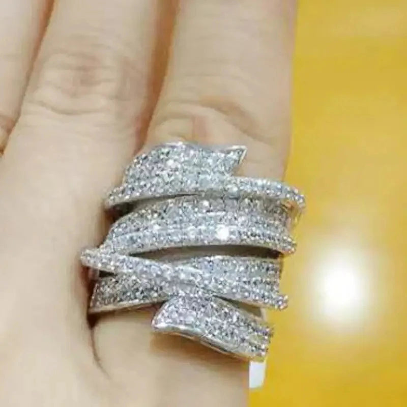 Cubic zirconia pave wide band ring stacked look on finger, silver-tone.