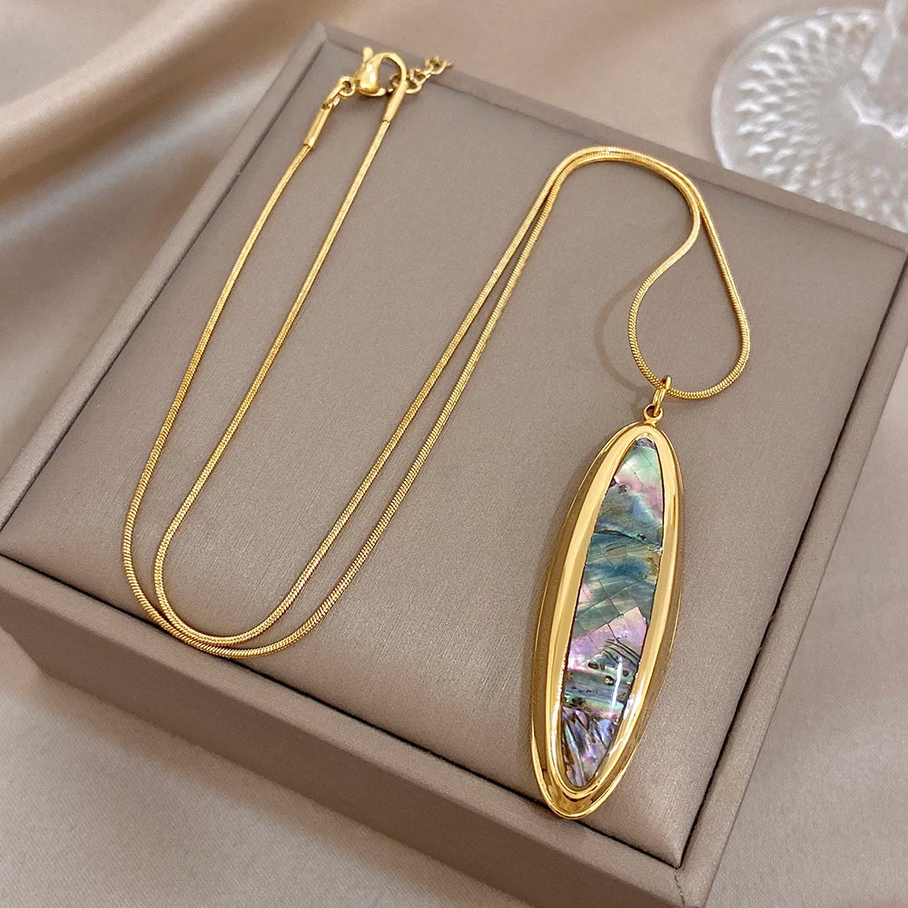 Gold oval abalone shell pendant necklace with thin snake chain and clasp