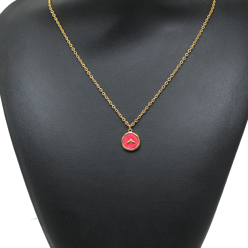 Pink enamel animal pendant on a gold-tone chain with a small gold loop bail