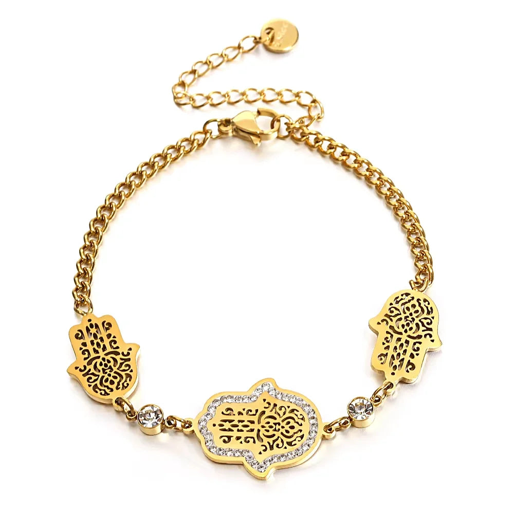 Gold-tone chain bracelet with three filigree hamsa charms and crystal accents