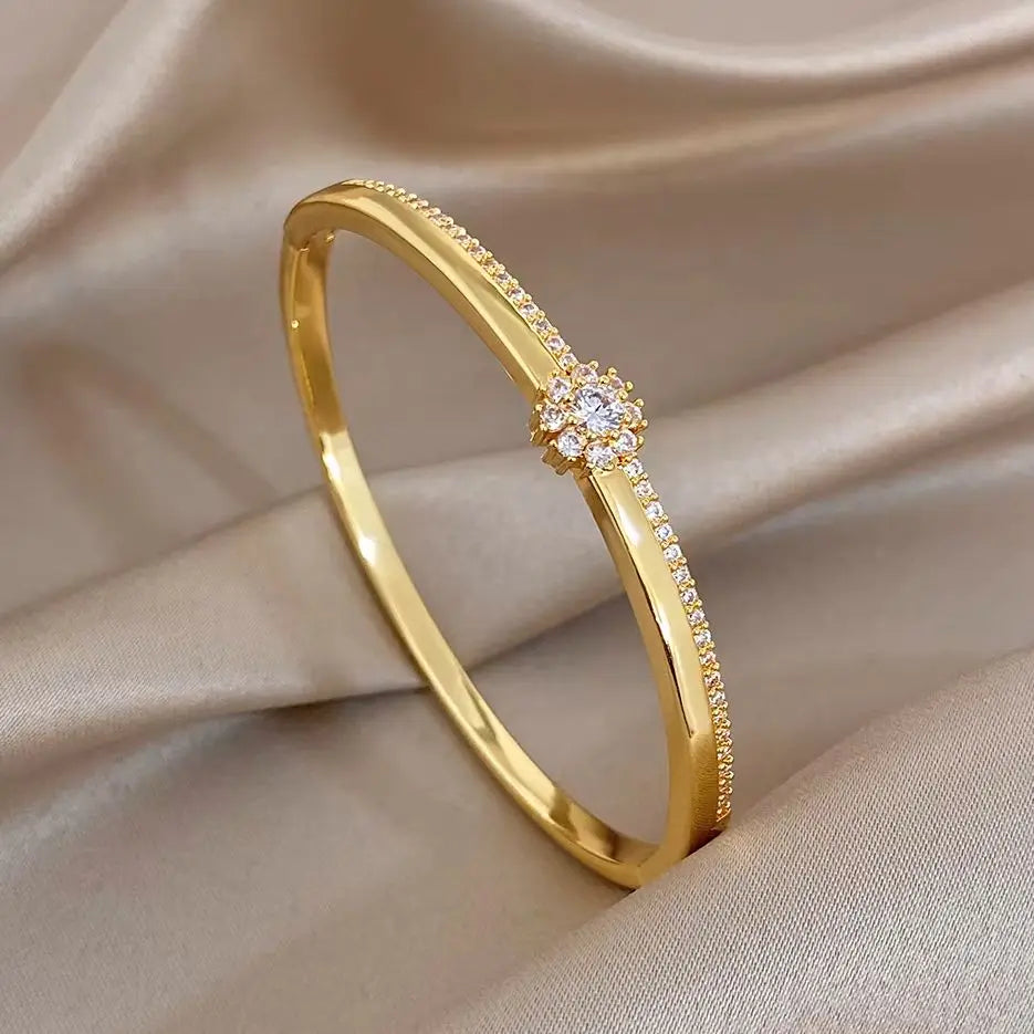 Gold-plated cuff bangle with zircon flower centerpiece, micro-inlaid stones
