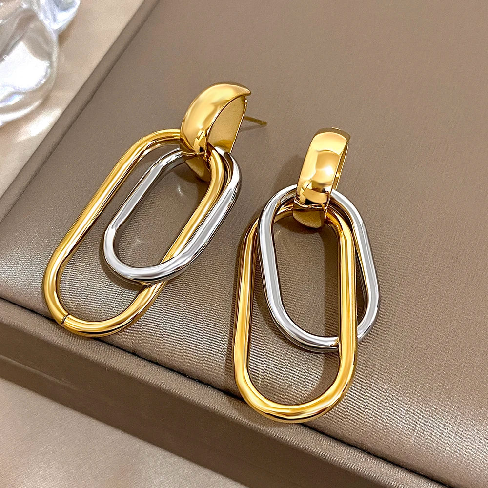 Pair of mixed-metal drop earrings with nested gold and silver oval links