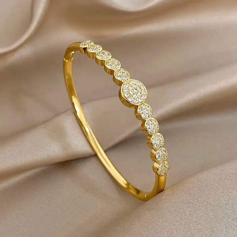 Gold-tone cuff bangle with round zircon stones