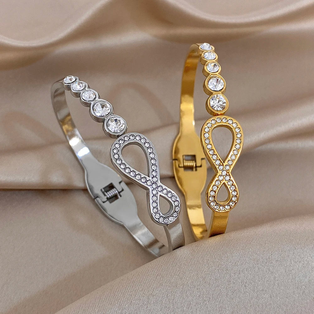 Gold- and silver-tone rhinestone infinity cuff bracelets with round crystal accents