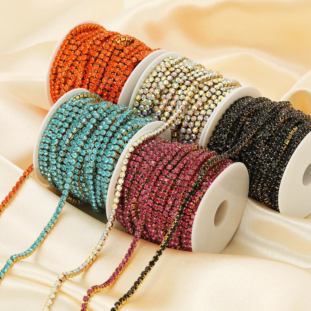 Rhinestone crystal chain tassel on white spools, orange, turquoise, pink, and black strands