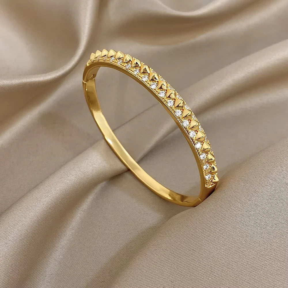 Gold-plated geometric zirconia rivet cuff bangle with continuous triangular stone row