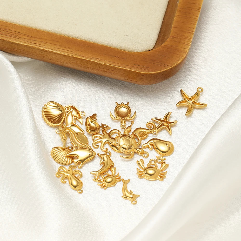 Gold-tone sea animal charm pieces with loop attachments