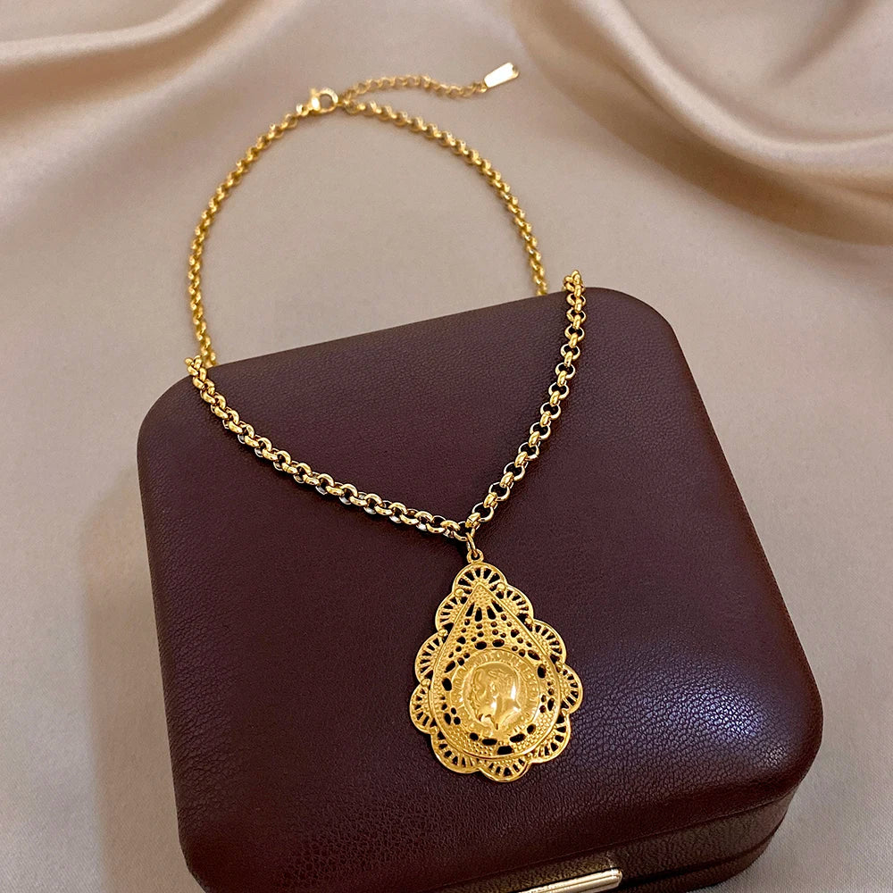 Gold-tone round filigree pendant necklace with lion coin center on chain