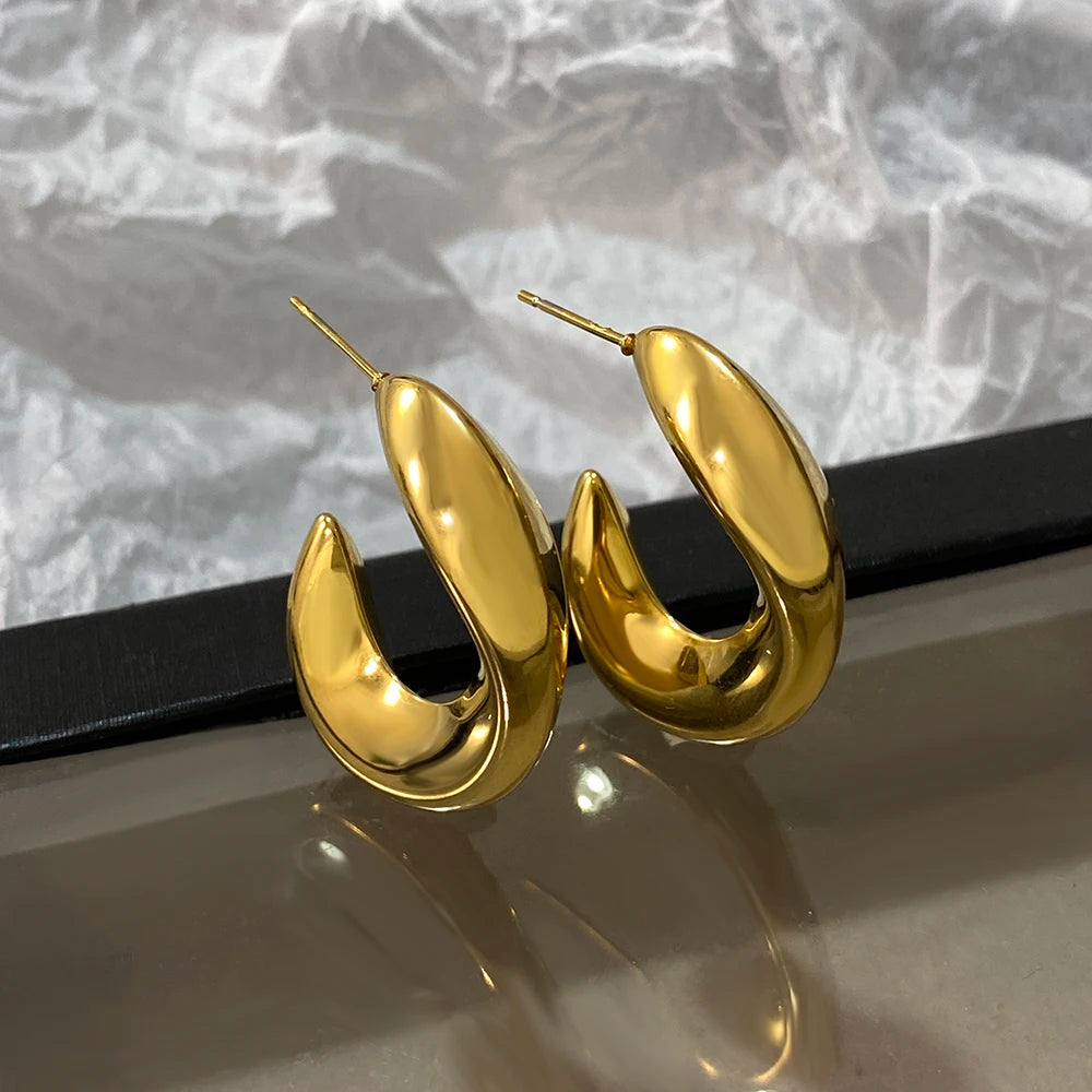 Gold-tone chunky hoop earrings with glossy sculpted curves and post backs