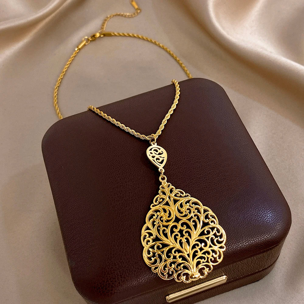 Gold-plated stainless steel necklace with teardrop filigree pendant and small round charm