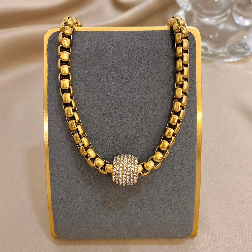 Gold-tone chunky bead chain choker necklace with round rhinestone center bead