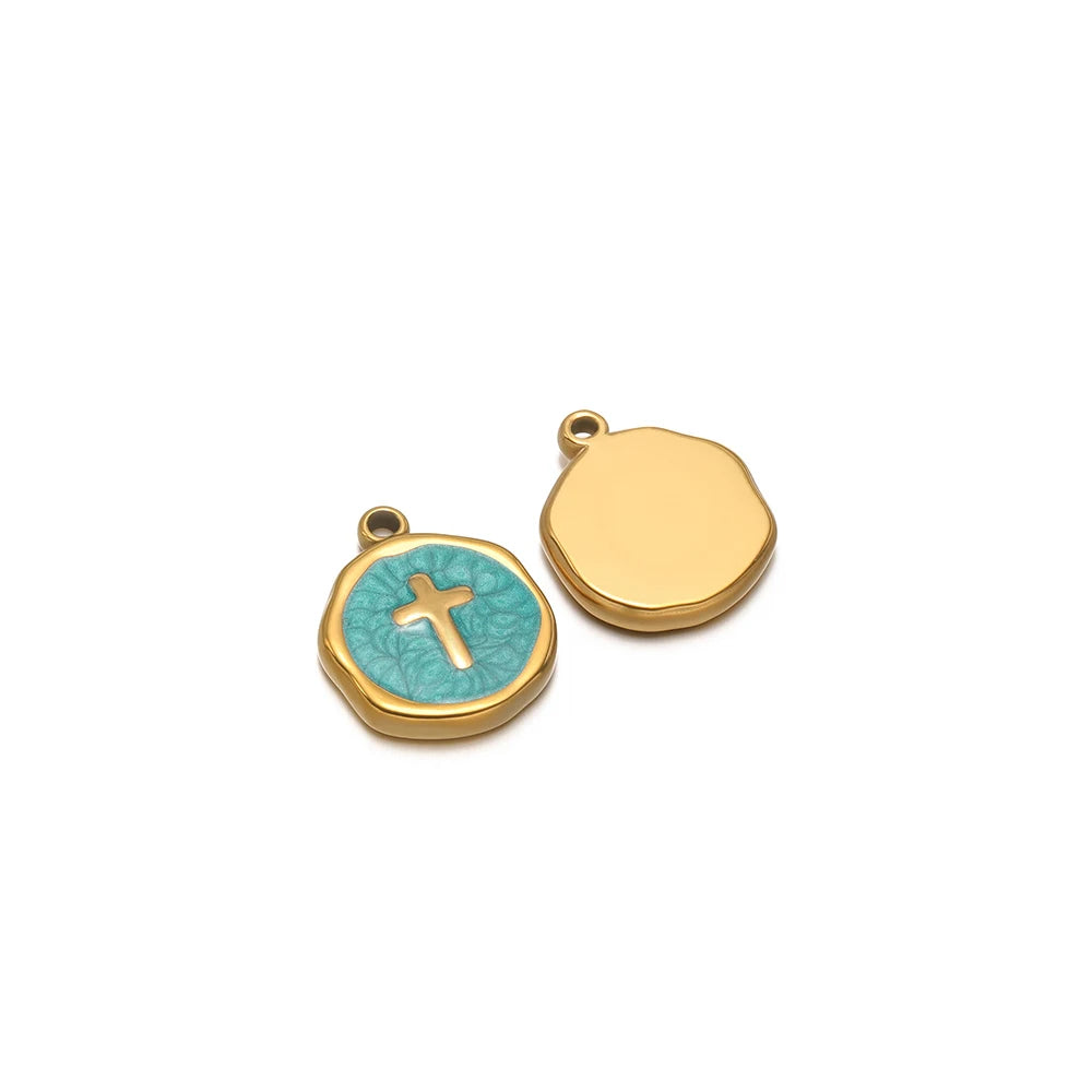 Two enamel charm pendants: gold blank disc and teal cross icon with gold loop