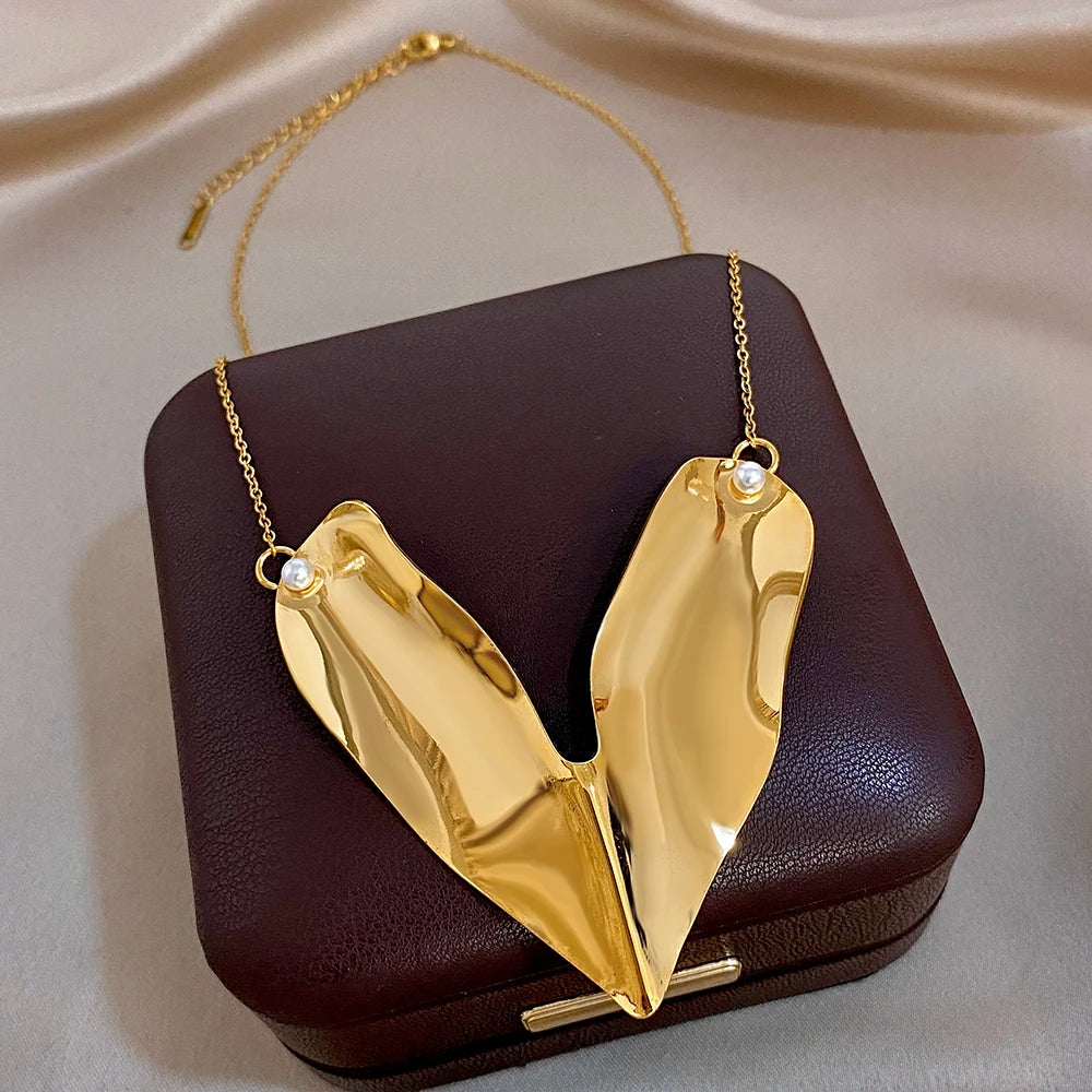 Gold-tone heart pendant collar necklace with two pearl beads on a fine chain