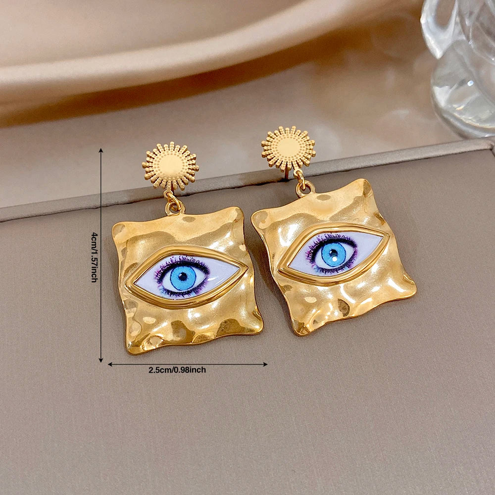 Hammered gold-tone evil-eye drop earrings, blue eye motif, sunburst tops (about 2.5 cm)