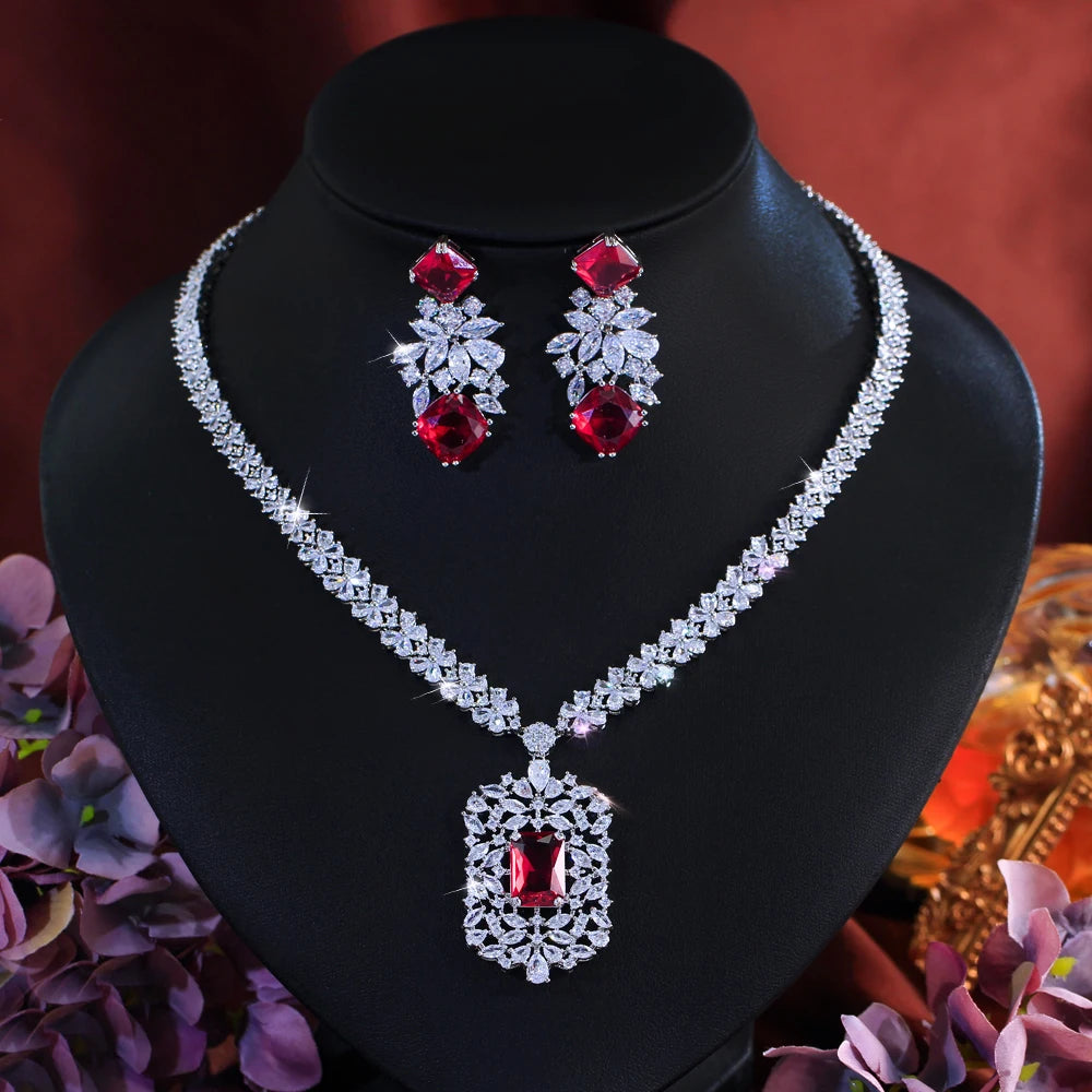 Cubic zirconia flower necklace and drop earring set with red stones and clear accents