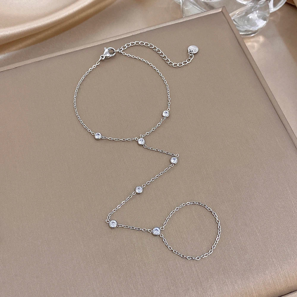 Silver zircon bead link bracelet set with small round stones and chain loop accents