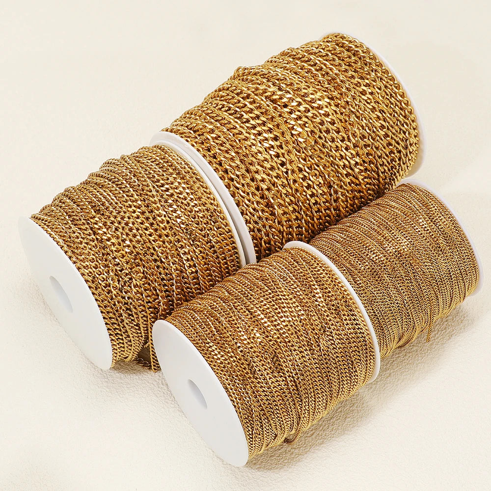 Gold-plated stainless steel Cuban link chain, coiled on white spools