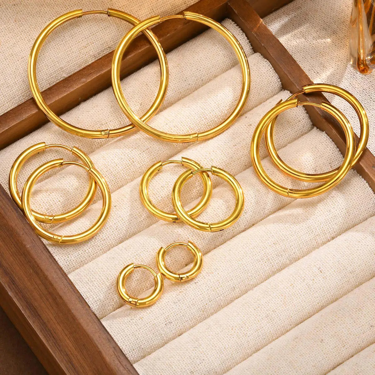 Gold hoop earrings in assorted sizes, arranged as pairs.