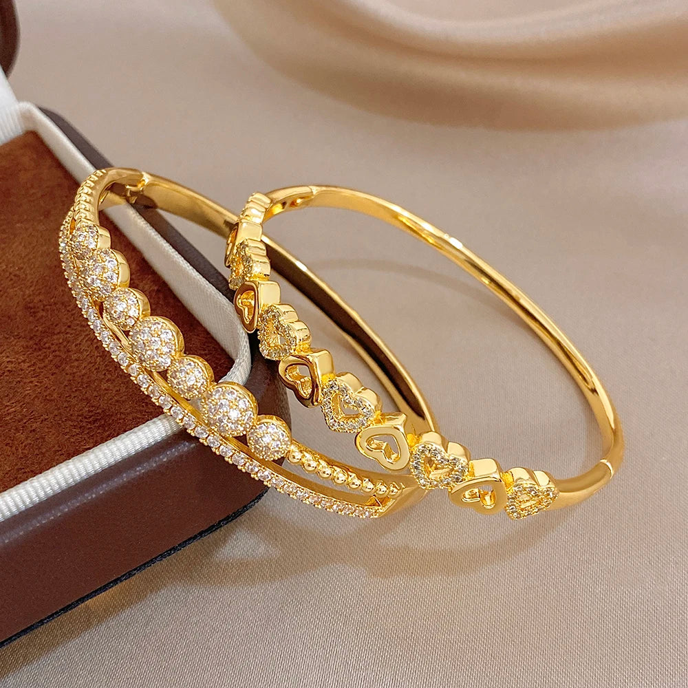 Gold-plated cuff bangle bracelet with heart and zircon details