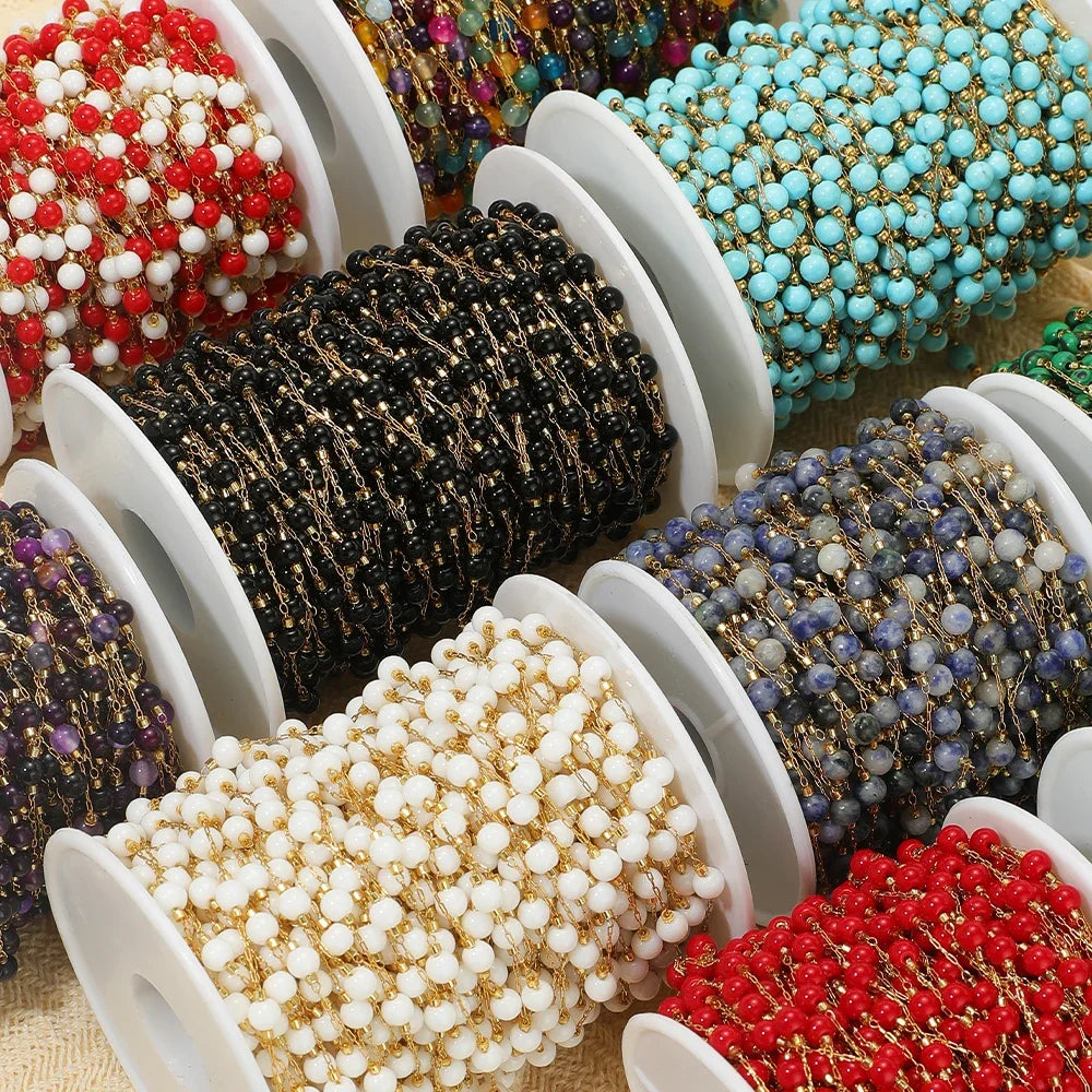 Assorted bead chain spools with gold-tone links and black, white, red, and purple beads