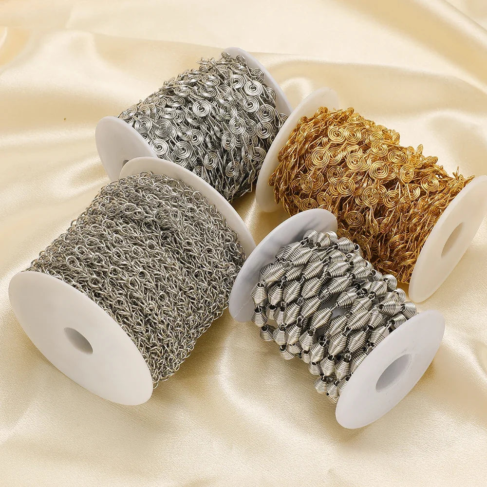 Four rolls of spiral chain in silver, gold, and gray shades for DIY jewelry