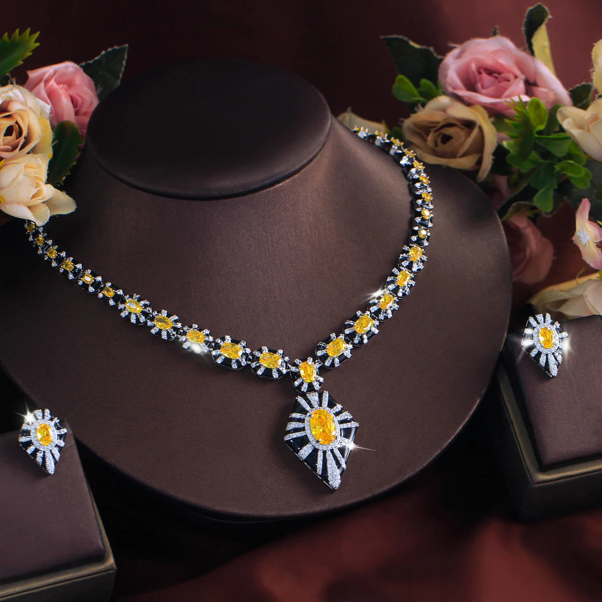 Yellow zircon necklace and matching earrings displayed on jewelry stands.