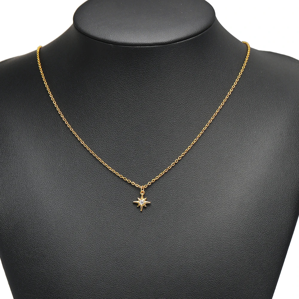 Gold-tone necklace with a small star pendant featuring rhinestones