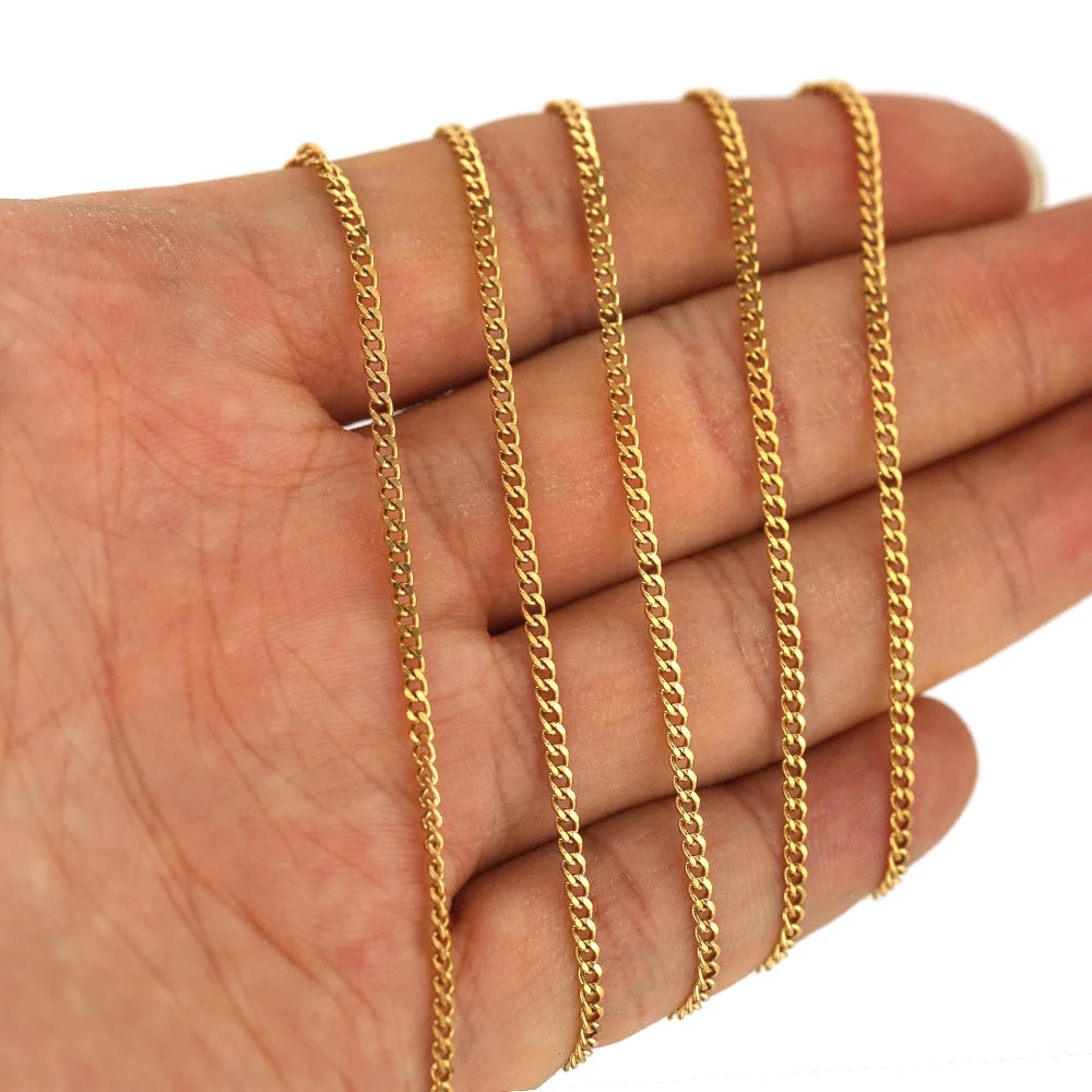 Gold curb Cuban link chain strands on hand, multiple lengths