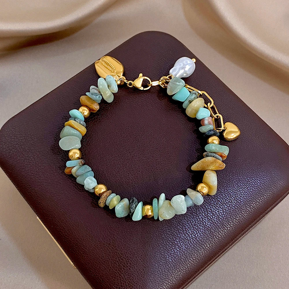 Gold chain bead bracelet with irregular stones in mint blue, cream, and brown; pearl shell charm