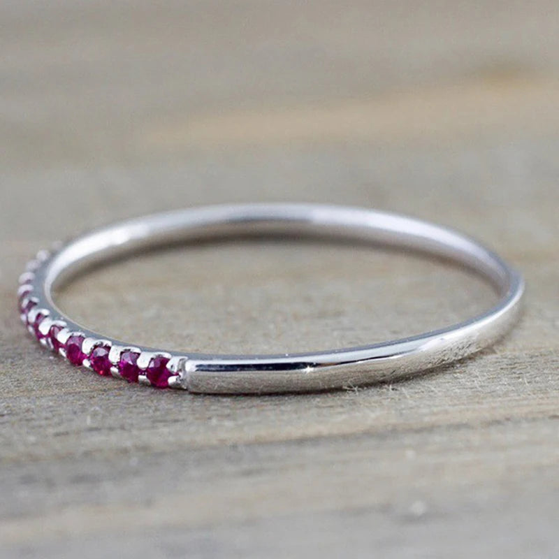 Silver ring with maroon CZ stones on the side of the band