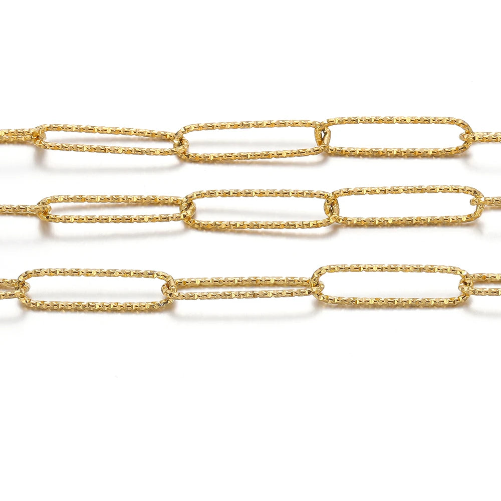 Gold oval link chain close-up showing smooth rectangular links and embossed texture