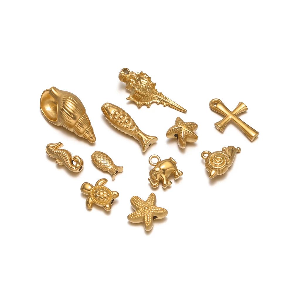 Assorted gold-toned marine animal charms, shells, starfish, elephant and cross pendants