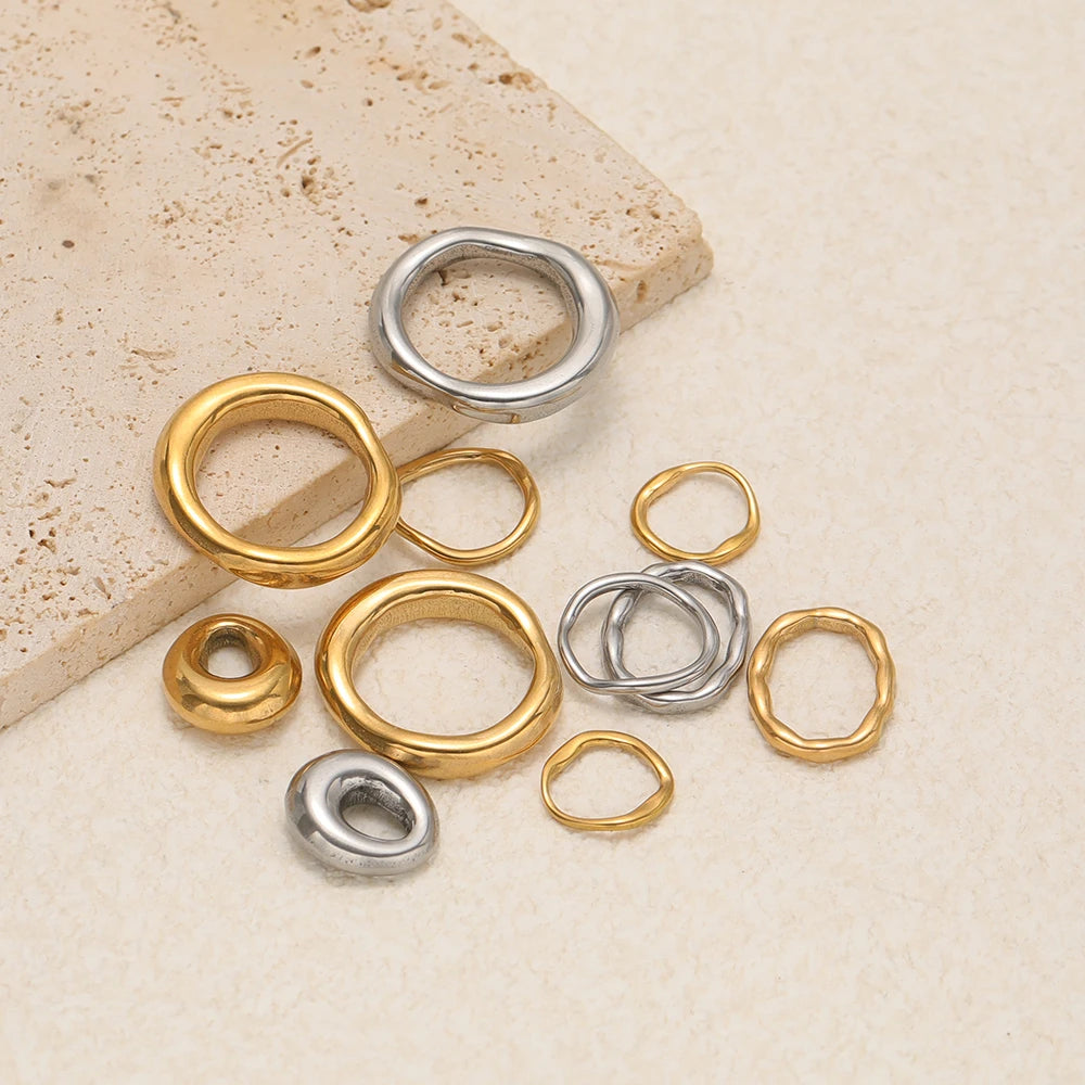 Set of five mixed gold and silver-tone open ring charms with small bead details