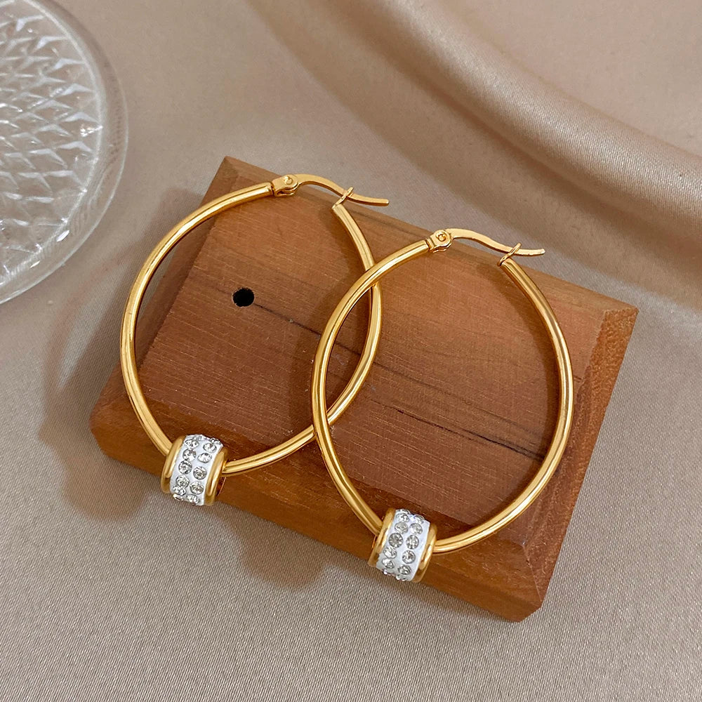 Gold-plated hoop earrings with clear rhinestone bead bands, shown as a matching pair