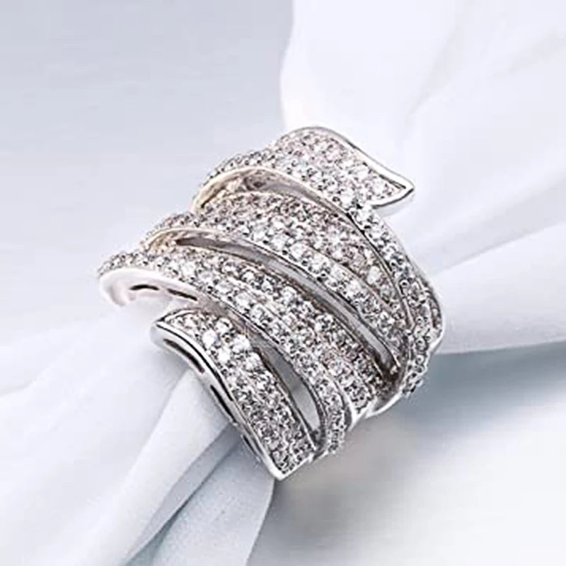 Wide silver-tone cubic zirconia pave irregular shaped ring with scalloped top.