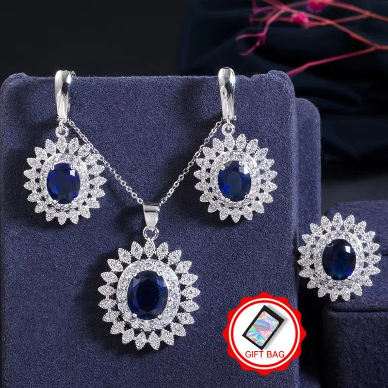 Blue oval cubic zirconia jewelry set with flower-halo earrings, pendant necklace, and ring