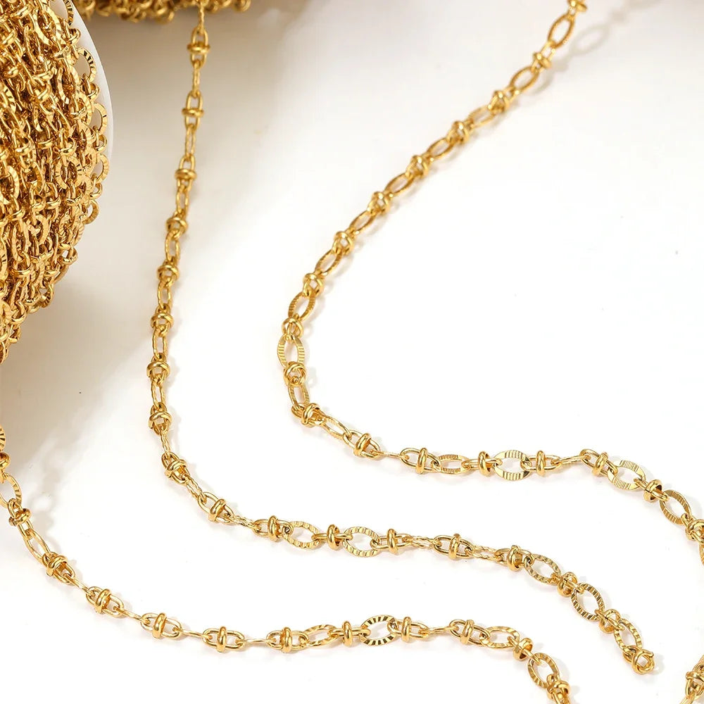 Close-up of gold and silver oval link chains with interlocking loops