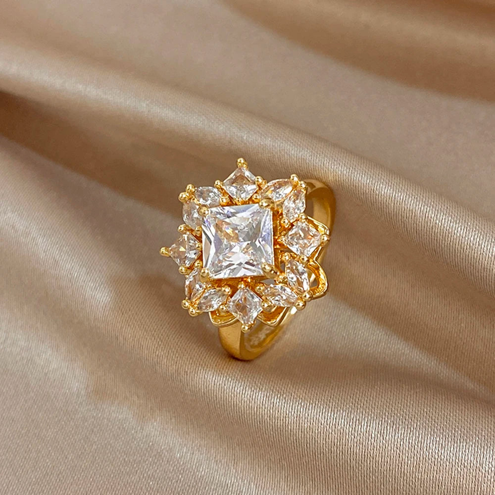 Gold-plated square halo ring with clear center zirconia and small sparkling stones